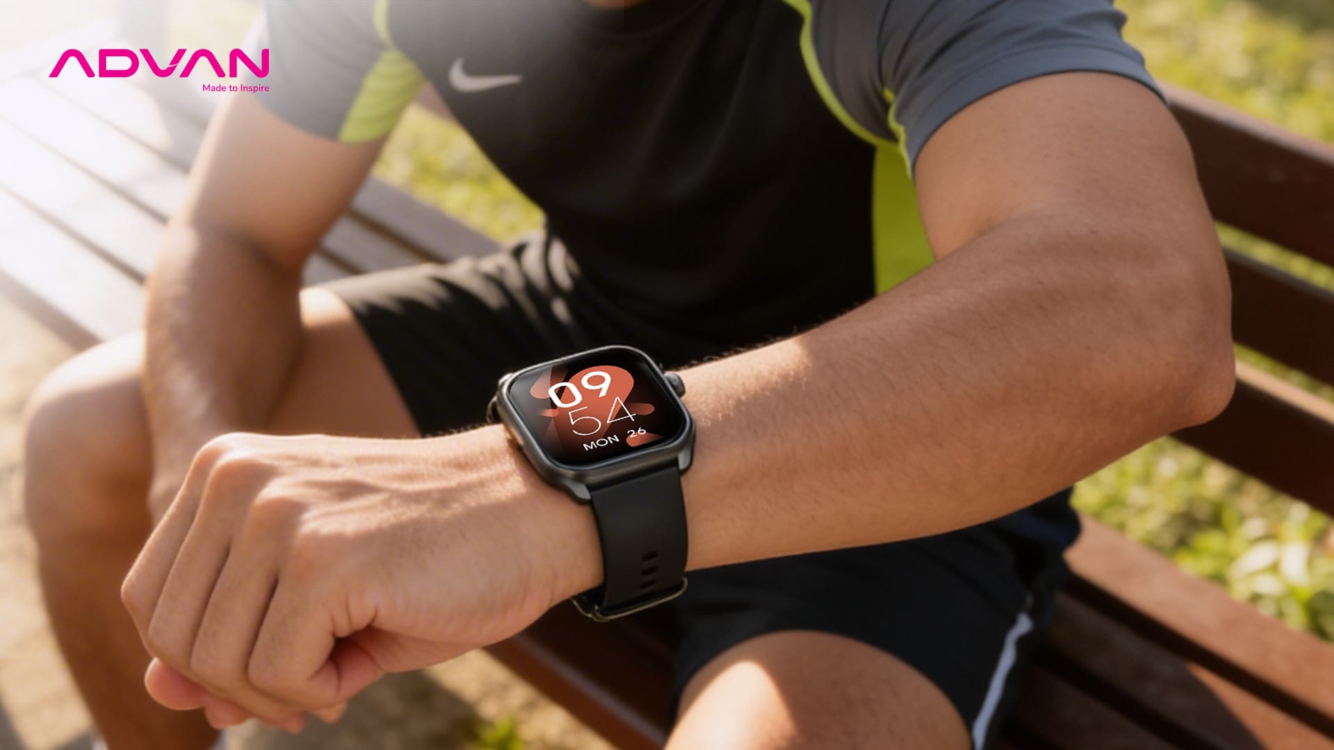 Pria berpakaian jogging duduk dibangku taman
sambil melihat Smartwatch-Nya
